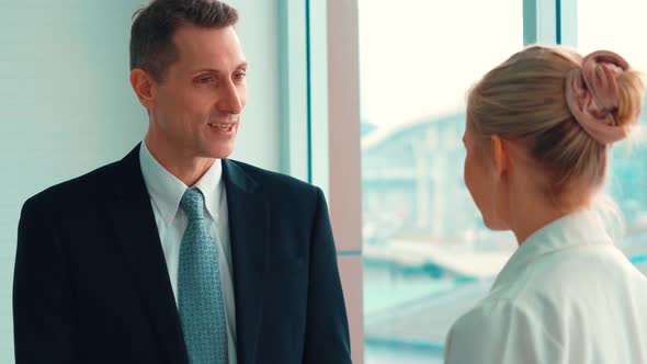 Two Business People Talk Project Strategy at Office alt