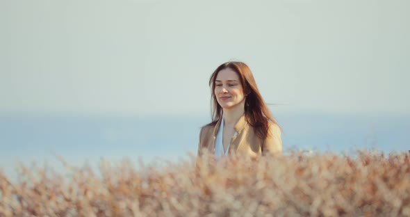 Happy Business Lady Goes Along Bush Plantings alt