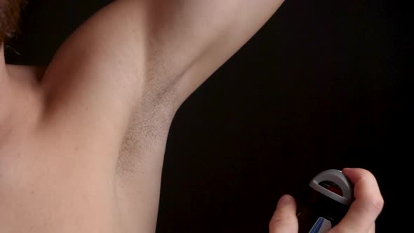 Man Using Deodorant Spray on His Armpit to Prevent Perspiration, Close-up alt