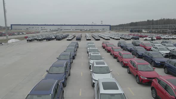 The New Cars are Lined Up in the Parking Lot Outside the Production Facility