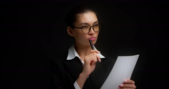 Business Woman Thinks What to Write on a White Piece of Paper alt