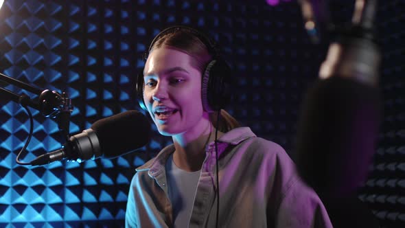 Beautiful Young Girl Dj Speaks Into Microphone Records Podcast or Morning News Show for Radio alt