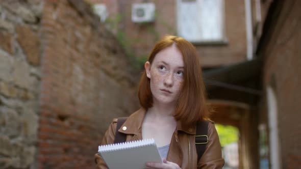 Ginger Girl Sketching in Alleyway alt