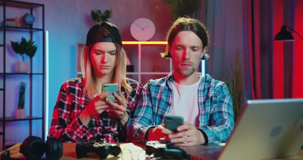 Young Couple Sitting Together at the Table at Home in the Evening alt