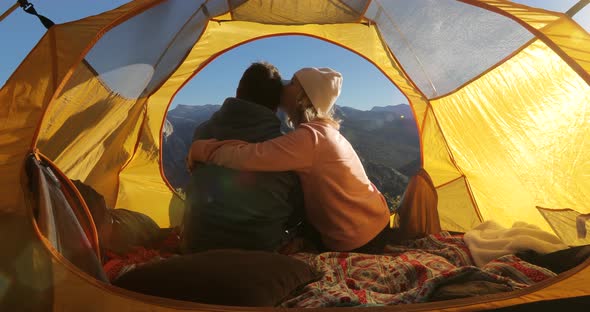Embrace of Two Lovers in a Tent Pierced By Dawn Rays in Yosemite Valley. California, USA alt