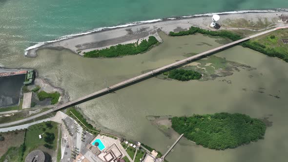 Anaklia, Georgia - July 16 2022: Aerial view of Anaklia-Ganmuhkuri Pedestrian Bridge at sunset alt