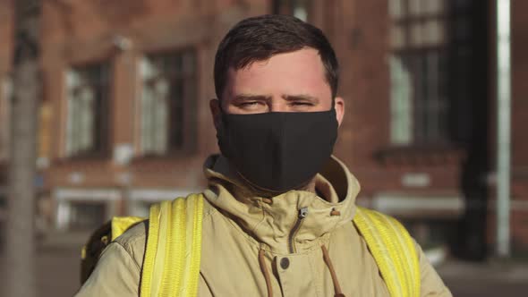 Delivery man turns to camera, takes off mask and deep breath