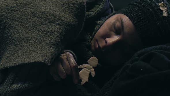 Homeless Teenager Holding Little Paper Men alt