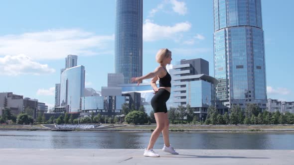 Woman dancing on street in city