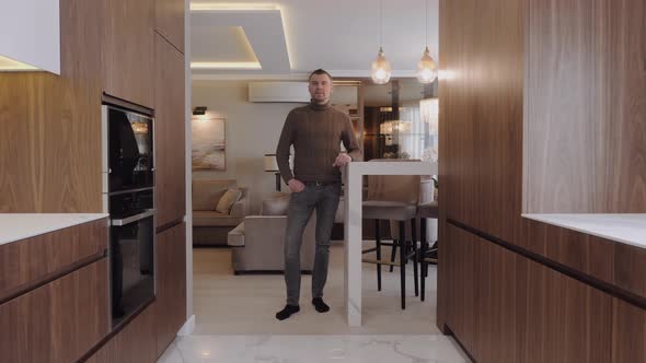 An Entrepreneur-designer Stands in the Middle of the Interior of a New House.