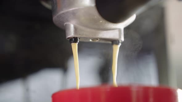 4k Slow motion B Roll of Pouring coffee stream from machine in cup.