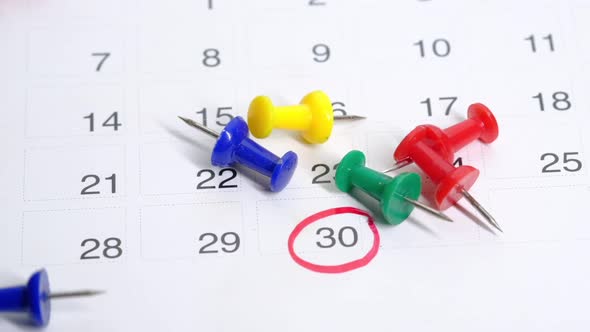 Deadline Concept with Many Push Pin Drops on Calendar Date Close Up alt