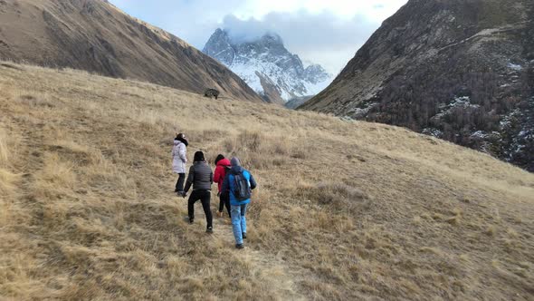 Group of People Climb to a Snowy Mountain