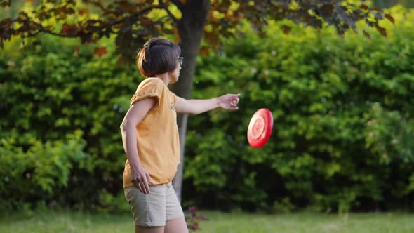 Woman Plays Frisbee on Grass Lawn alt