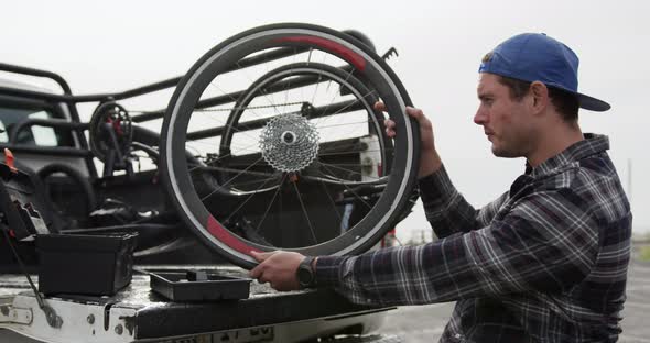 Disabled man looking at the wheel of his chair alt