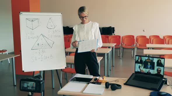 A Lady is Doing a Geometry Lesson Via the Internet alt