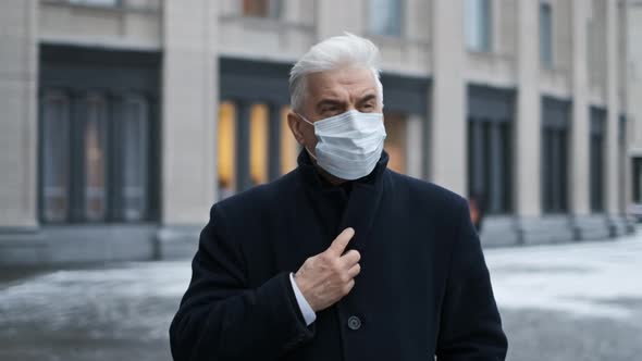 Retired Sick Man in Black Coat Mask Walks on Street During Coronavirus Pandemic