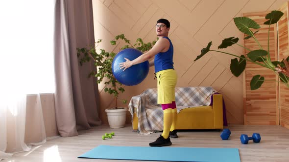 Man Performs Squats with Fitness Ball in Hands at Home Retro Sports Uniform Front View alt