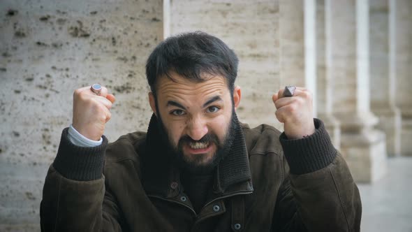 funny man making the gesture of strength with his arms in the street alt