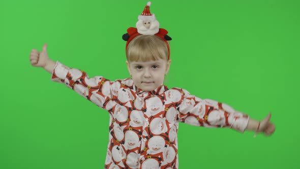Happy Beautiful Little Girl in a Shirt with a Santa Claus alt