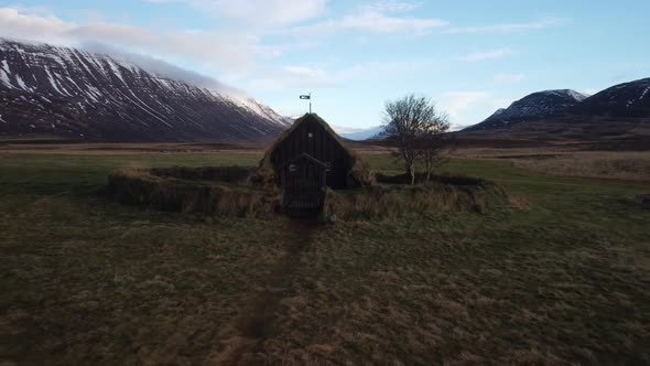 Aerial view pull back of young girl walking to chucrh in Iceland alt