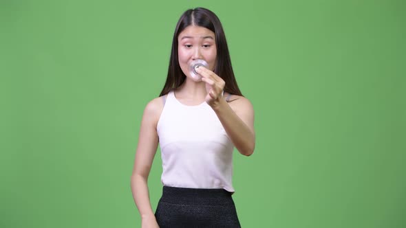 Young Beautiful Asian Businesswoman Playing with Fidget Spinner