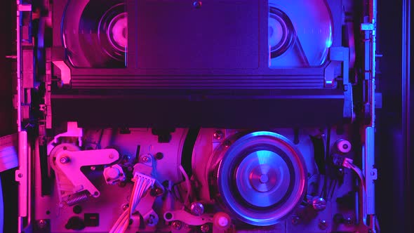 Video cassette player working, VHS rewind, retrofuturistic blue and purple light alt