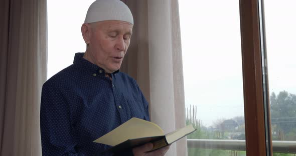 An Old Muslim Man Reading Koran