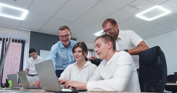 Colleagues Rejoice at Their Success at Work alt