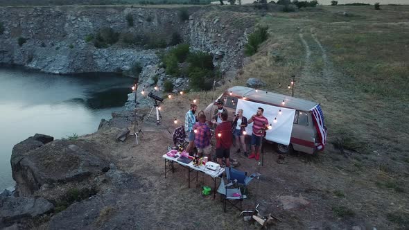 Friends Having Rest in Campsite Having Drinks