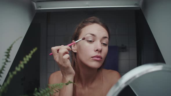 Beautiful Woman Applying Make Up