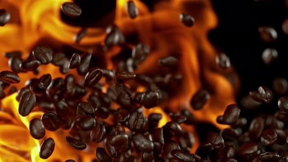 Super Slow Motion Shot of Flames and Coffee Beans Explosion on Black Background at 1000Fps alt