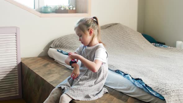 Little Girl Using Smartwatches