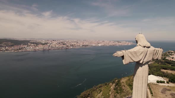 Cristo Rei Sanctuary looking over Tejo River and Lisbon riverside cityscape alt