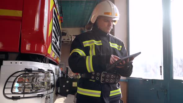 Fireman in Cabin Check Data in Digital Tablet alt