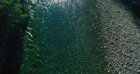 Low Altitude Flight Over Fresh Fast Mountain River with Rocks at Sunny Summer Morning. alt