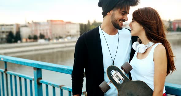 Picture of Young Attractive Couple Carrying Skateboards