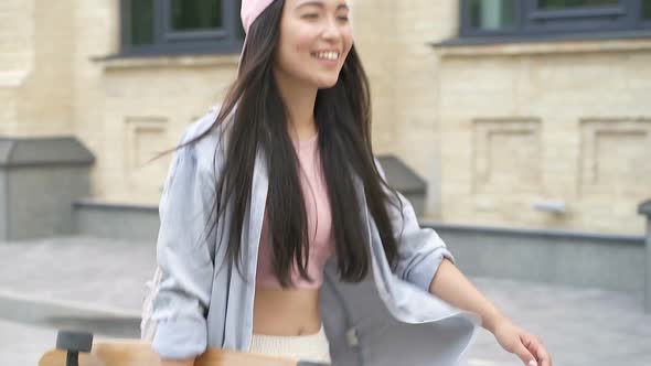 Woman walking with skateboard