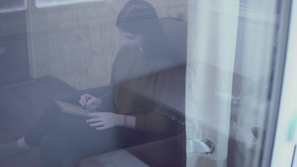 Young Woman in Window Draws Making Sketch in Notebook Painting with Coal Pencil