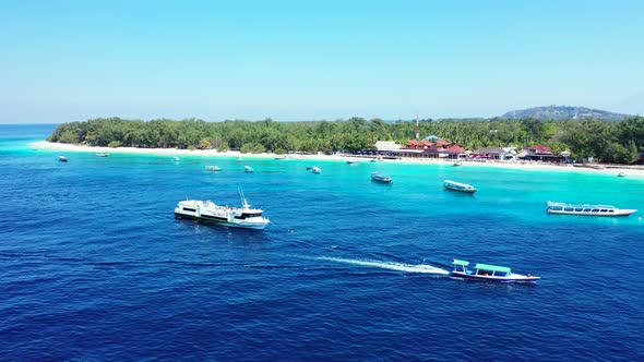 Island In Vanuatu - Boats Swiftly Sailing Over The Deep Blue Ocean Water Near The Lush Island On A S alt