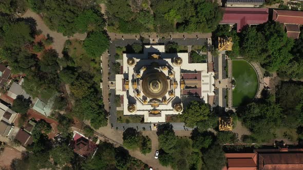 Top down tracking Aerial view of Buu Long Pagoda, a beautiful Buddhist temple with large gold roof s alt