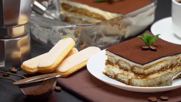Portion of Traditional Italian Tiramisu Dessert Cup of Espresso and Baking Dish alt