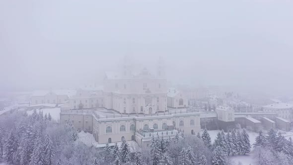 The Pochaev Lavra in the Fog at the Winter in Cloudy Day Aerial View alt