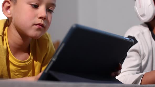 Boy Playing Video Games on Tablet
