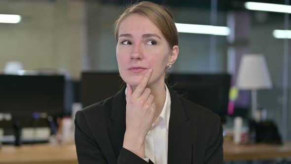 Portrait of Young Businesswoman Thinking and Getting Idea alt