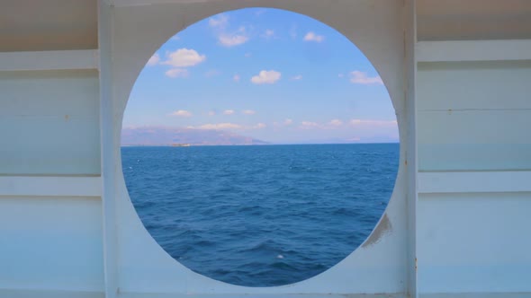 Summer Seascape From Round Window of the Yacht. Water Transport. Travel Concept. View of the Sea