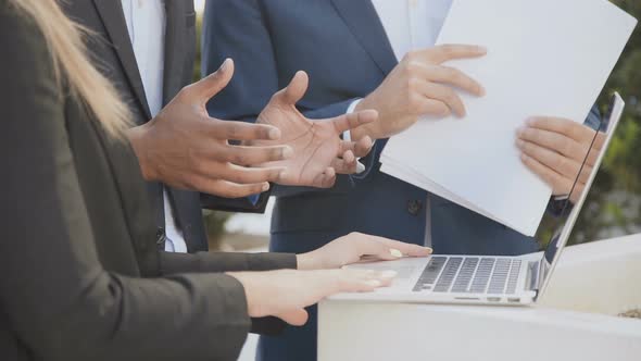 Business Colleagues with Laptop and Papers Outdoor alt