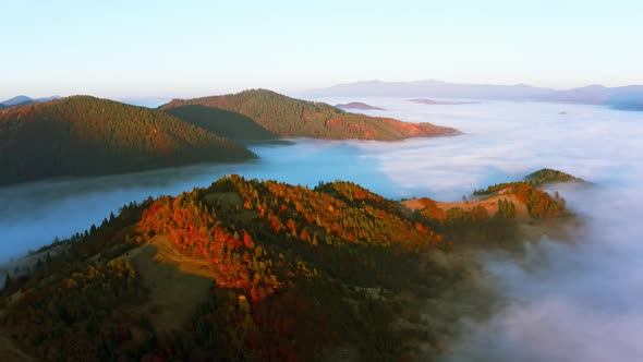 Sunrise Light Among Clouds Above Mountainous Canyon in Mist alt