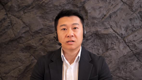 Close Up Asian Customer Support Operator Assistant Working Online at Helpdesk alt