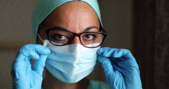 Young female medic, wearing a mask and glasses